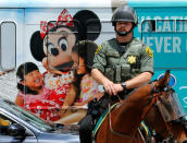 A member of the Orange County Sheriff watches demonstrators before U.S. Republican presidential candidate Donald Trump speaks at a campaign event in Anaheim, California, U.S., May 25, 2016. REUTERS/Mike Blake