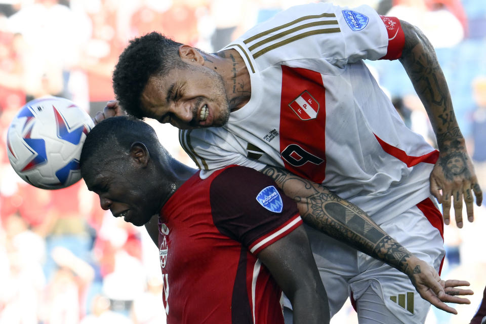 Peru's Paolo Guerrero, right, and Canada's Kamal Miller battle for a header during a Copa America Group A soccer match in Kansas City, Kan., Tuesday, June 25, 2024. (AP Photo/Reed Hoffmann)