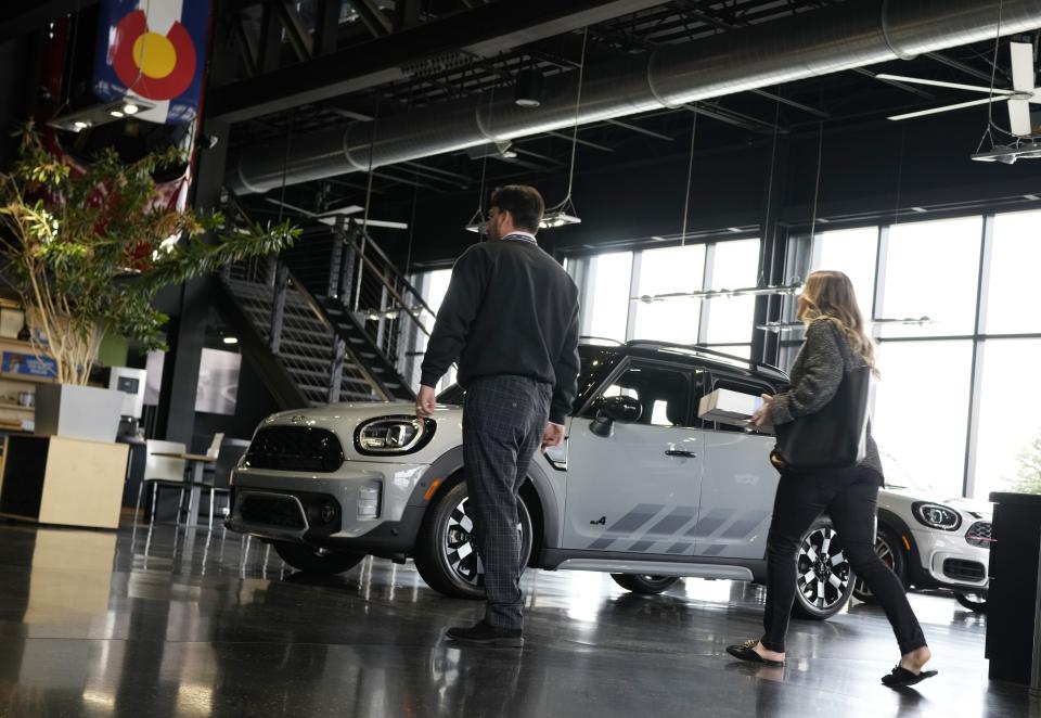 Potential buyers survey 2023 Cooper Countryman S sports-utility vehicle on the showroom floor of a Mini dealership Nov. 3 in Highlands Ranch, Colo. New car prices are starting to go down slightly after record highs in the summer.