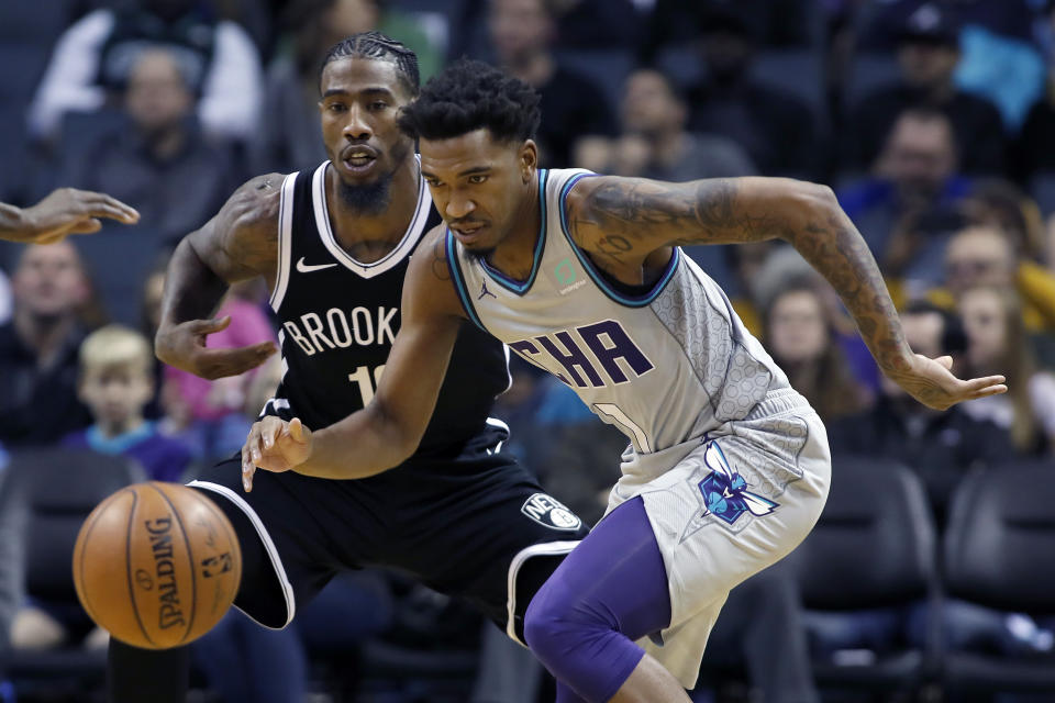 Charlotte Hornets' Malik Monk (1) chases down a loose ball before Brooklyn Nets' Iman Shumpert (10) can recover during the second half of an NBA basketball game in Charlotte, N.C., Friday, Dec. 6, 2019. The Nets won 111-104. (AP Photo/Bob Leverone)