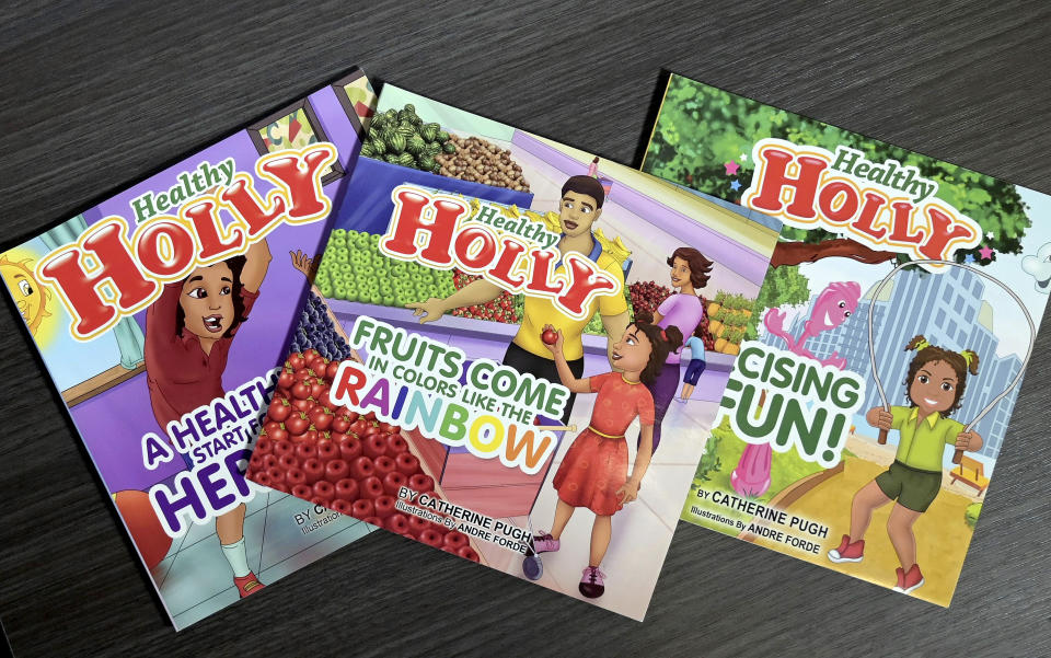 FILE -In this March 14, 2019, file photo, copies of former Baltimore Mayor Catherine Pugh's self-published "Healthy Holly" illustrated paperbacks for children are seen in Baltimore. The disgraced former mayor of Baltimore is scheduled to be sentenced during a hearing on Thursday, Feb. 27, 2020. (Jerry Jackson/The Baltimore Sun via AP, File)