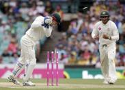 Australian wicket keeper Peter Nevill knocks off the bails to run out West Indies batsman Marlon Samuels (not pictured) as Australian team mate Usman Khawaja watches during their third cricket test at the SCG in Sydney, January 3, 2016. REUTERS/Jason Reed