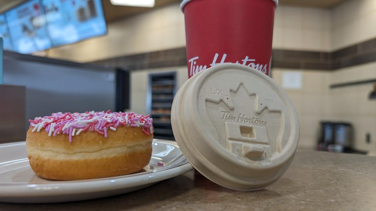 Tim Hortons is rolling out new fibre-based lids for coffee and other hot drinks at its Prince Edward Island locations over the next few months. The feedback from Island customers will help refine the product for a nationwide launch.  (Ken Linton/CBC News - image credit)