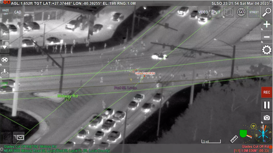 Still capture from St. Lucie County Sheriff's Office helicopter video of March 4, 2023, incident described as part of a "street takeover" at Glades Cut Off and Midway roads. Car in center is depicted doing doughnuts or burnouts.
