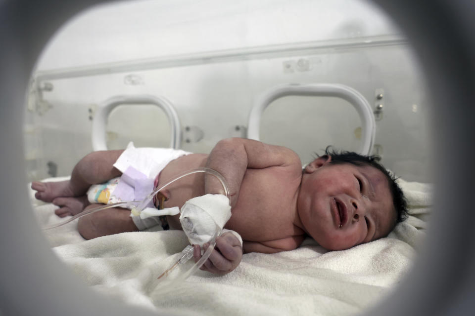 A baby girl who was born under the rubble caused by an earthquake that hit Syria and Turkey receives treatment inside an incubator at a children's hospital in the town of Afrin, Aleppo province, Syria, Tuesday, Feb. 7, 2023. (AP Photo/Ghaith Alsayed)