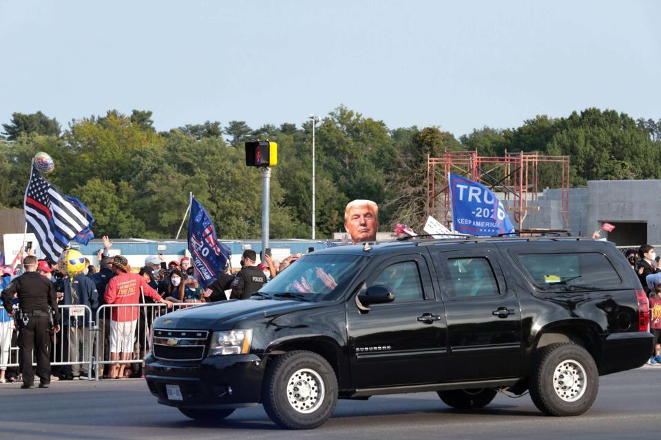 The president greeted supporters from his car on Sunday (REUTERS)