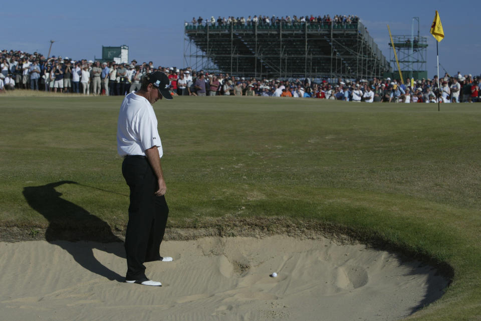 Thomas Bjorn looks down at the ball in the bunker