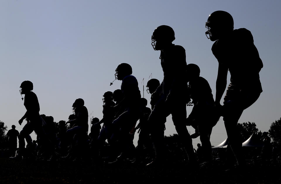 Chicago Bears players warm up during an NFL football training camp in Bourbonnais, Ill., Sunday, July 28, 2019. (AP Photo/Nam Y. Huh)