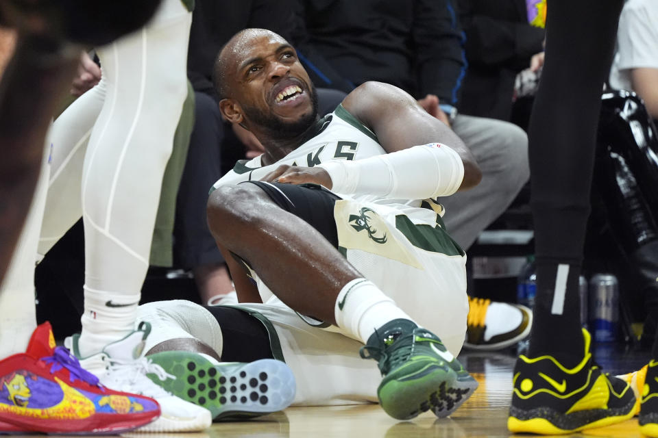 Milwaukee Bucks forward Khris Middleton grimaces on the court after being injured during the first half of the team's NBA basketball game against the Phoenix Suns on Tuesday, Feb. 6, 2024, in Phoenix. (AP Photo/Ross D. Franklin)