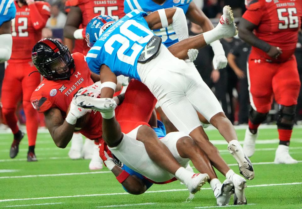 Dec 28, 2022; Houston, Texas, USA;Texas Tech Red Raiders wide receiver Jerand Bradley (9) is tackled by Mississippi Rebels cornerback Davison Igbinosun (20) in the first half in the 2022 Texas Bowl at NRG Stadium. Mandatory Credit: Thomas Shea-USA TODAY Sports