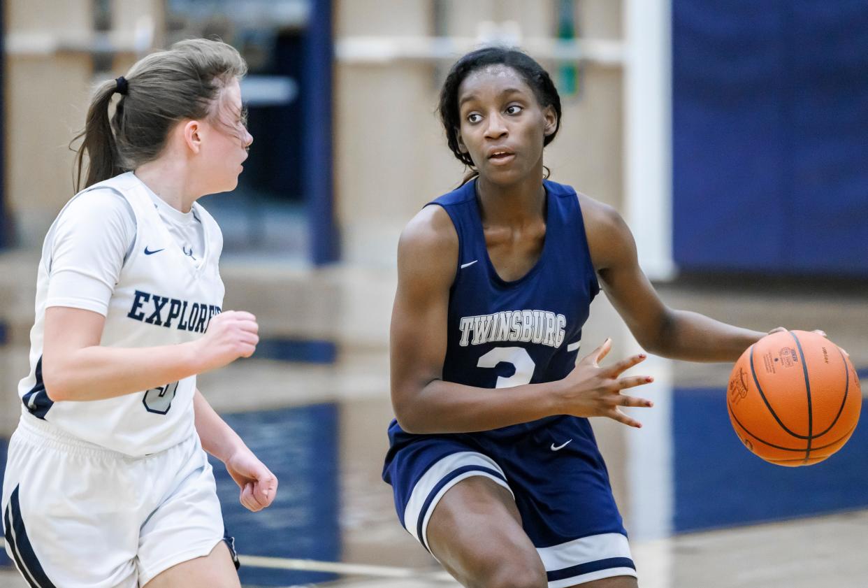 Twinsburg's Logan Pride brings the ball up the court against Hudson's Paige Albrecht during the Tigers' 55-40 home loss to the the Explorers.