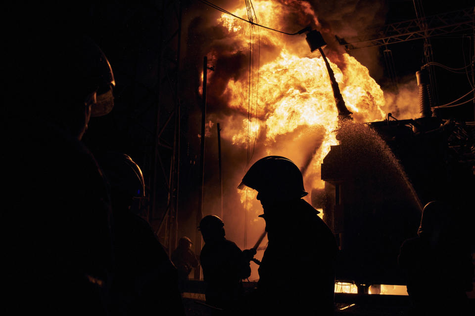 Ukrainian State Emergency Service firefighters put out a fire after a Russian rocket attack hit an electric power station in Kharkiv, Ukraine, Sunday, Sept. 11, 2022. The Kharkiv and Donetsk regions are completely without power due to the rocket attack.(AP Photo/Kostiantyn Liberov)