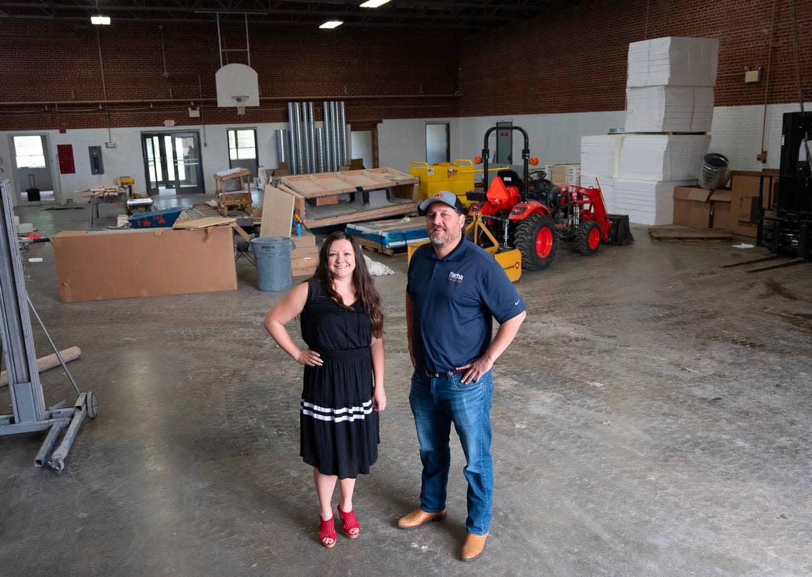 Lindsey Brown vice president of operations for Farha Roofing and Ben Farha, owner and president, stand in the space they will move their headquarters into In July. The company is moving from its current much smaller space near Harry and Hillside into the 21,000-square-foot former National Guard Armory on Edgemoor just north of Central.