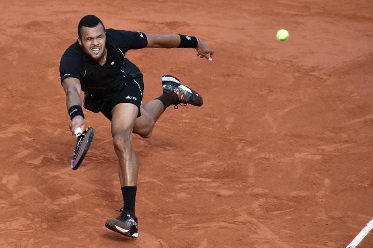 France's Jo-Wilfried Tsonga returns the ball to Japan's Kei Nishikori during the men's quarter-finals of the Roland Garros 2015 French Tennis Open in Paris on June 2, 2015