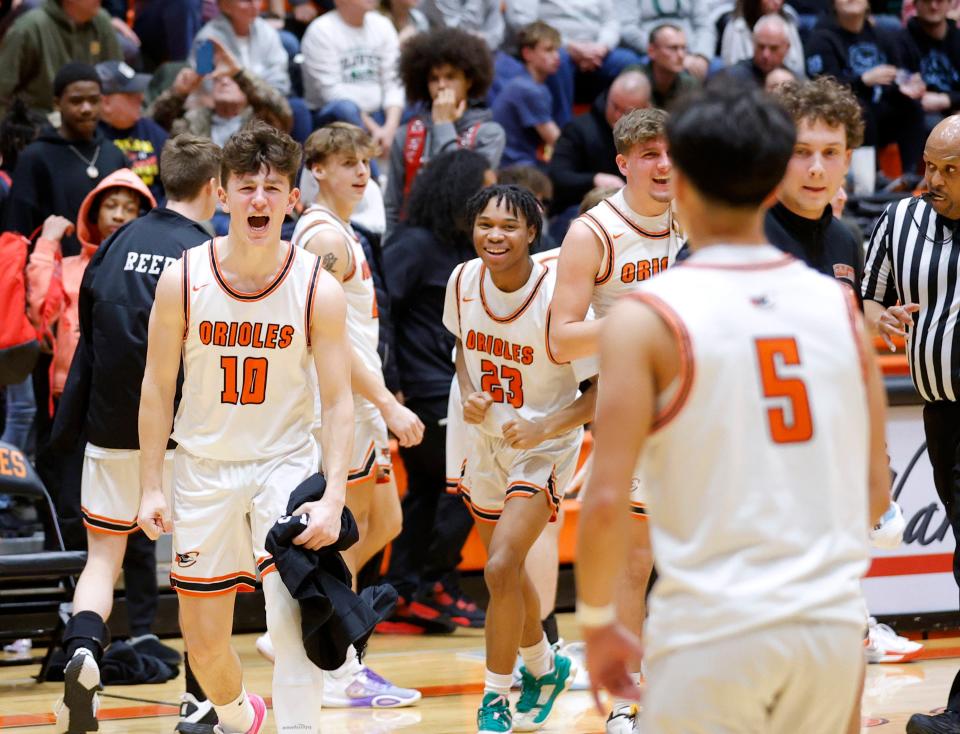 Charlotte players celebrate their 59-54 win over Olivet in their district semifinal, Wednesday, Feb. 28, 2024, at Charlotte High School.