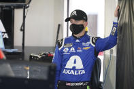 William Byron watches as crew members ready his car in the garage before the start of a NASCAR Daytona 500 auto race practice session at Daytona International Speedway, Wednesday, Feb. 10, 2021, in Daytona Beach, Fla. (AP Photo/John Raoux)