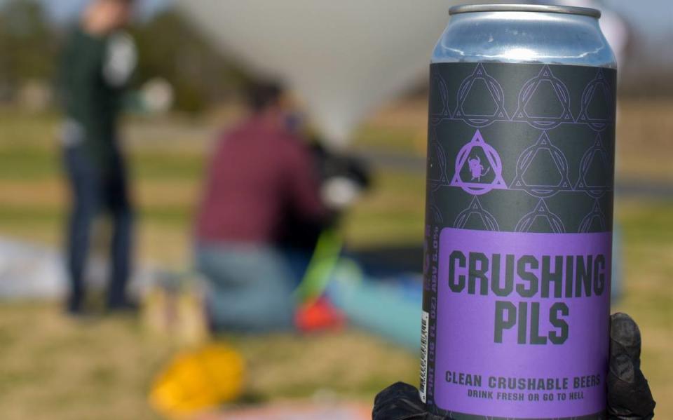 Devil’s Logic is known for its “crushable beers.” Here, a German Pilsner stands front and center as the team preps for its weather balloon experiment.