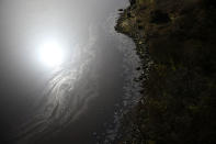 The sun is reflected in Lough Foyle which is part of the Northern Ireland border near Londonderry, Northern Ireland, February 21, 2018. REUTERS/Clodagh Kilcoyne SEARCH "KILCOYNE BORDER" FOR THIS STORY. SEARCH "WIDER IMAGE" FOR ALL STORIES. - RC158EAC98C0