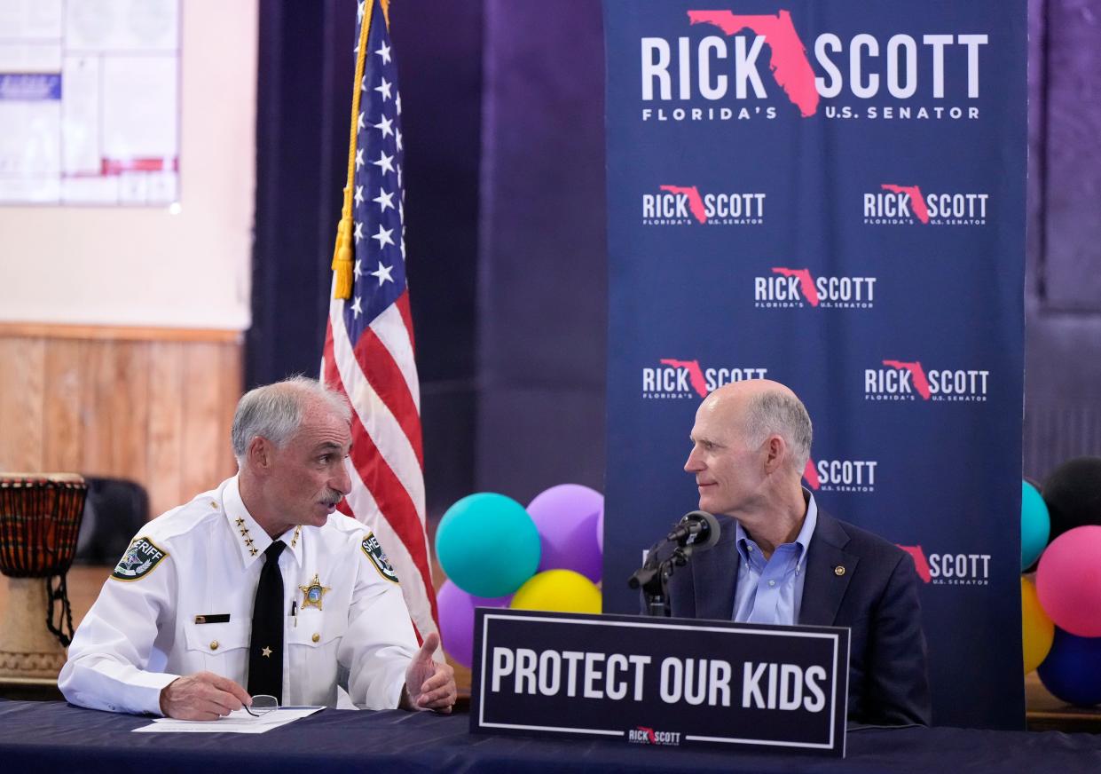 Volusia County Sheriff Mike Chitwood, left, speaks with U.S. Sen. Rick Scott at a "Keeping Our Kids Safe" roundtable discussion at the Lacey Family/Spring Hill Boys & Girls Club in DeLand Wednesday.