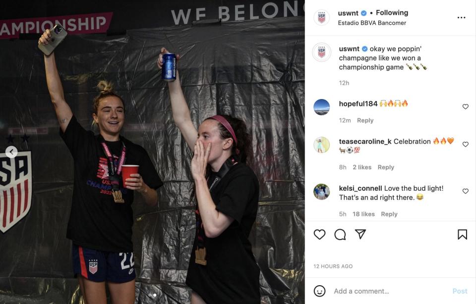 Midfielders Kristie Mewis (left) and Rose Lavelle (right) celebrate in the locker room.