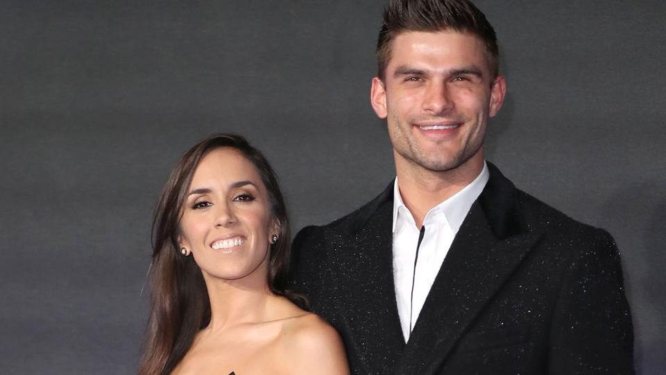 Janette Manrara in a strapless dress and Aljaz Skorjanec in a black coat