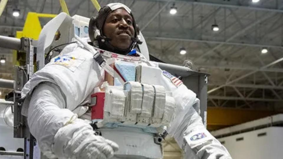 an astronaut in a spacesuit in a large warehouse