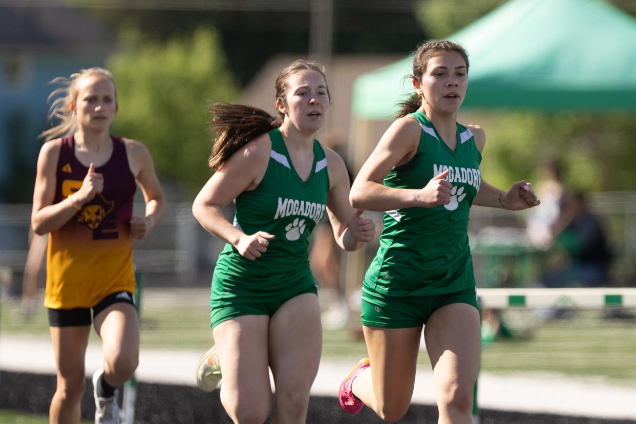 Mogadore’s Katie Lane and Emma Quillen lead the pack in the girls 1,600 meters at the Portage Trail Conference Track & Field Championships Friday, May 10, 2024 in Mogadore.