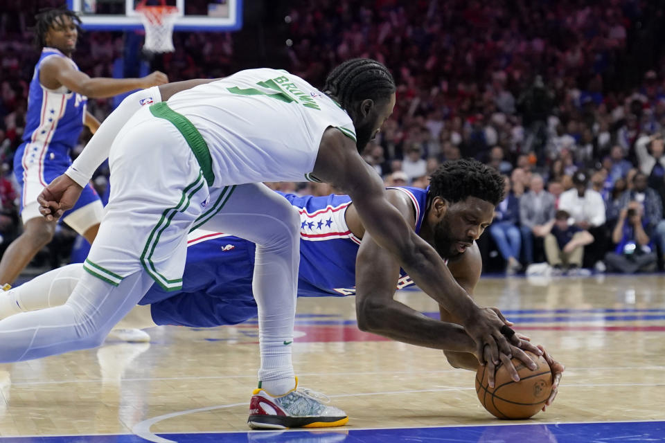 Philadelphia 76ers' Joel Embiid, right, and Boston Celtics' Jaylen Brown reach for the ball during the second half of Game 6 of an NBA basketball playoffs Eastern Conference semifinal, Thursday, May 11, 2023, in Philadelphia. (AP Photo/Matt Slocum)