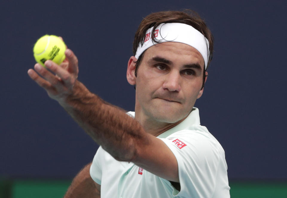 Roger Federer, of Switzerland, serves to Filip Krajinovic, of Serbia, during the Miami Open tennis tournament, Monday, March 25, 2019, in Miami Gardens, Fla. (AP Photo/Lynne Sladky)