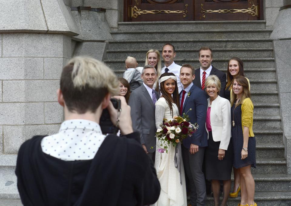 A couple poses for a photograph with members of their wedding party on Sept. 27, 2014, after their wedding ceremony inside the Salt Lake Temple in Salt Lake City. (Photo: Robert Alexander via Getty Images)