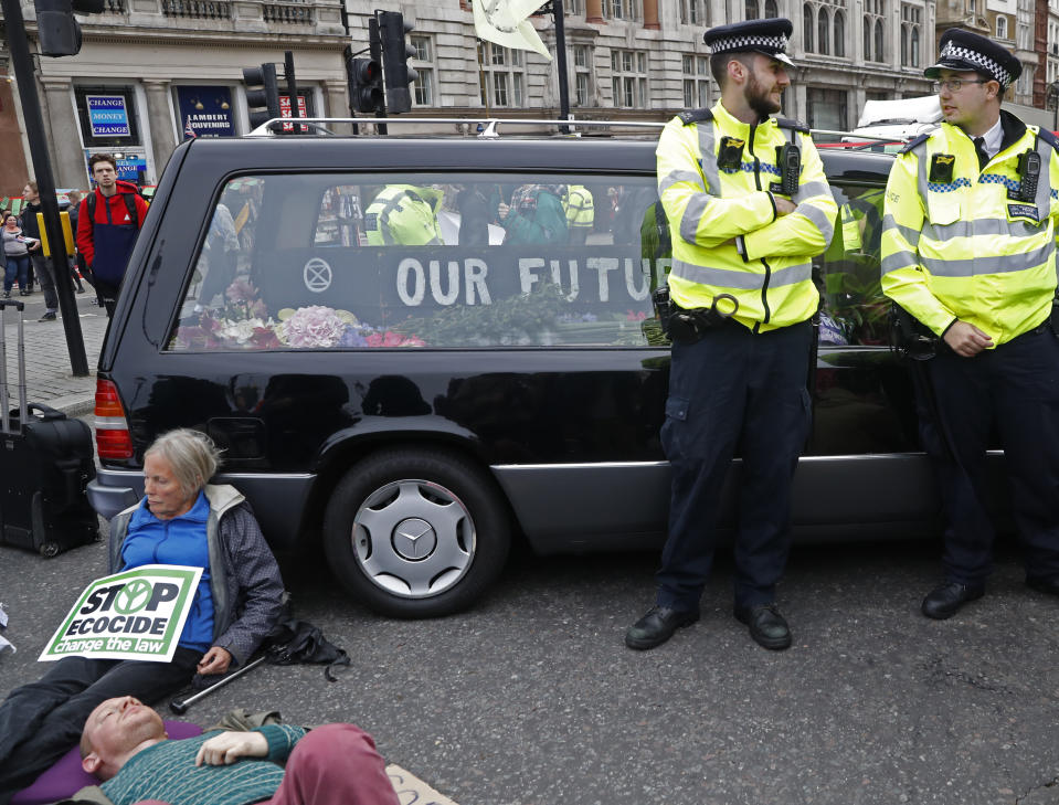 A hearse carrying "Our Future" in a coffin blocks Trafalger Square in central London Monday, Oct. 7, 2019. Extinction Rebellion movement blocked major roads in London, Berlin and Amsterdam on Monday at the beginning of what was billed as a wide-ranging series of protests demanding new climate policies. (AP Photo/Alastair Grant)