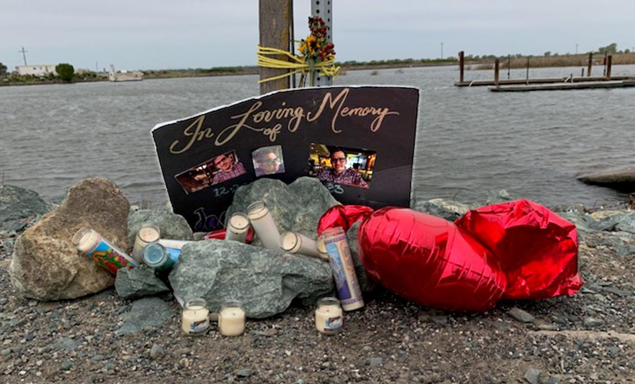 A roadside memorial lays near where the white Honda Pilot of Jacob VanZant. 24, of Lodi, who had been missing since Feb. 17, was found was found by divers under water about 150 feet from the shore of Little Potato Slough at the west end of Eight Mile Road in Stockton.