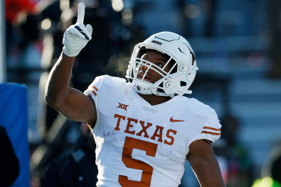 Texas running back Bijan Robinson reacts after scoring against Kansas during the first half of an NCAA college football game on Saturday, Nov. 19, 2022, in Lawrence, Kan. Robinson was selected to The Associated Press All-America team released Monday, Dec. 12, 2022.