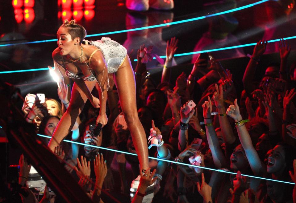 FILE - In this Aug. 25, 2013 file photo, Miley Cyrus performs at the MTV Video Music Awards at the Barclays Center in New York. Her infamous performance on the MTV Video Music Awards, showed her twerking her way in pop culture history in a teddy bear leotard that segues to a skimpy nude bikini. (Photo by Charles Sykes/Invision/AP, File)