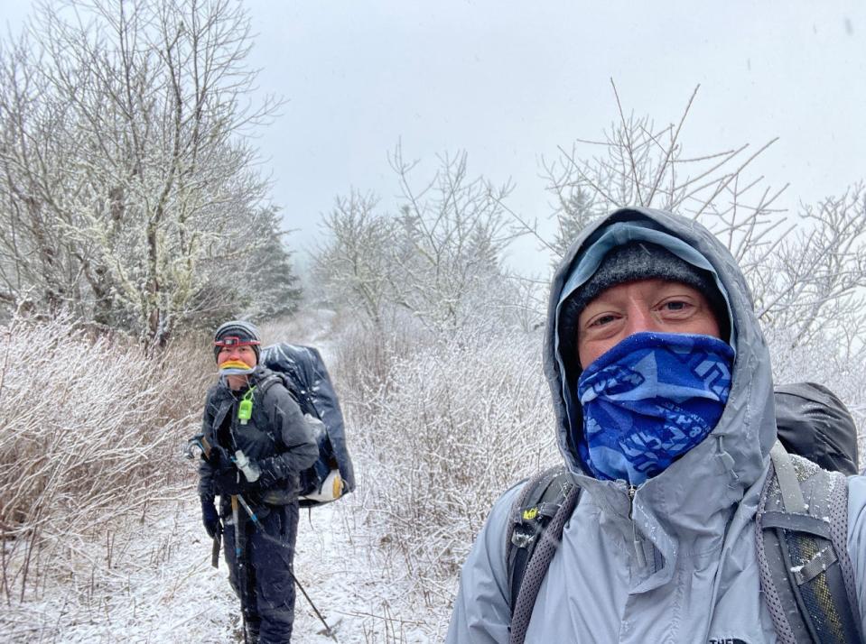 Aron Goss takes a picture with a fellow hiker in the Smoky Mountains coming over Max Patch.