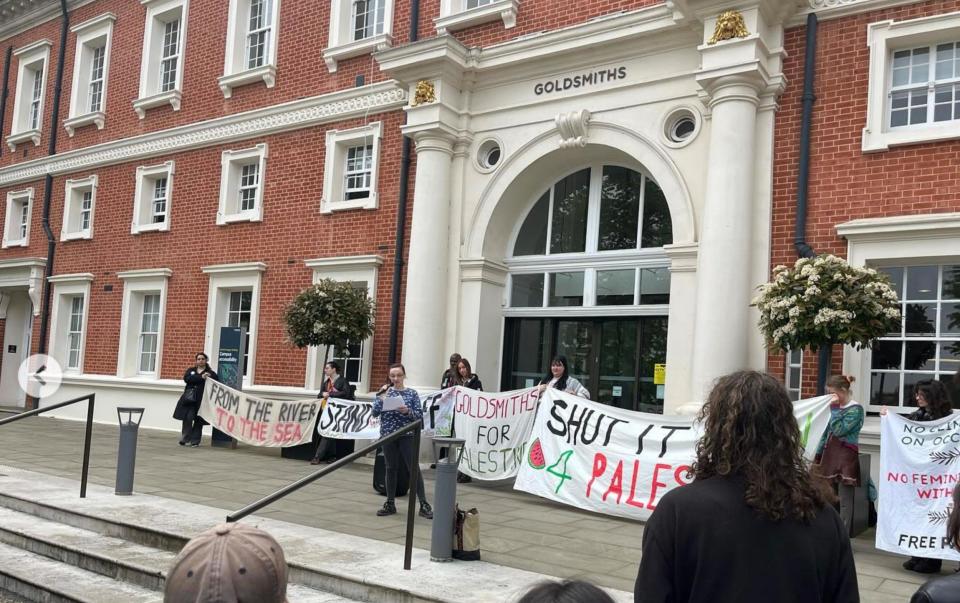 Goldsmiths students hold banners saying 'From the river to the sea' and 'Goldsmiths for Palestine' in front of one of the university's buildings
