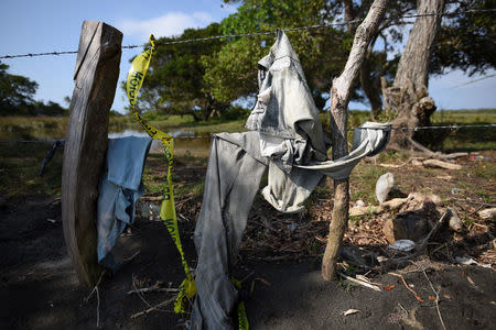 Clothing is pictured on a wire fence at site of unmarked graves where a forensic team and judicial authorities are working in after human skulls were found, in Alvarado, in Veracruz state, Mexico, March 19, 2017. REUTERS/Yahir Ceballos
