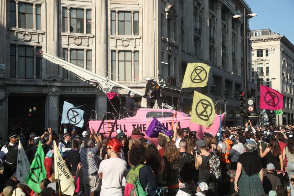 Police take control of Extinction Rebellion’s ‘Tell the Truth’ boat, during a protest in Oxford Circus, London  (PA Archive)