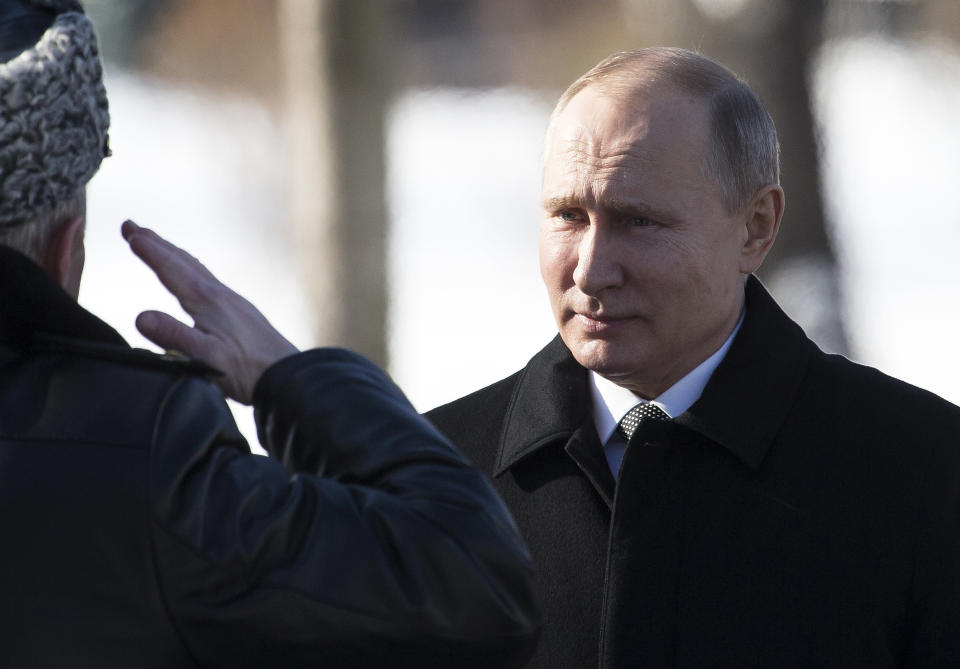 FILE - In this Friday, Feb. 23, 2018 file photo, Russian President Vladimir Putin, right, listens to the Defense Minister as he arrives to attend a wreath-laying ceremony at the Tomb of the Unknown Soldier in Moscow, Russia. The GRU is one arm of Russia's extensive security and intelligence apparatus, which also includes the Foreign Intelligence Service, known as the SVR, and the Federal Security Service, or FSB, which conducts domestic intelligence and counterintelligence. (AP Photo/Alexander Zemlianichenko, File)