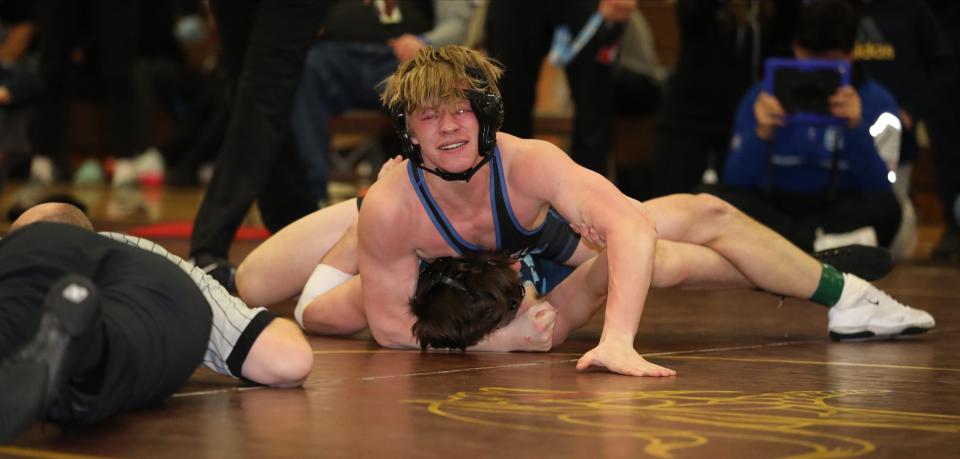 Nikita Rusnak from Carmel on his way to defeating Brandon DellaPia from John Jay EF in the 152 pound match during the wrestling divisional at Clarkstown South High School in West Nyack, Feb. 3, 2024.