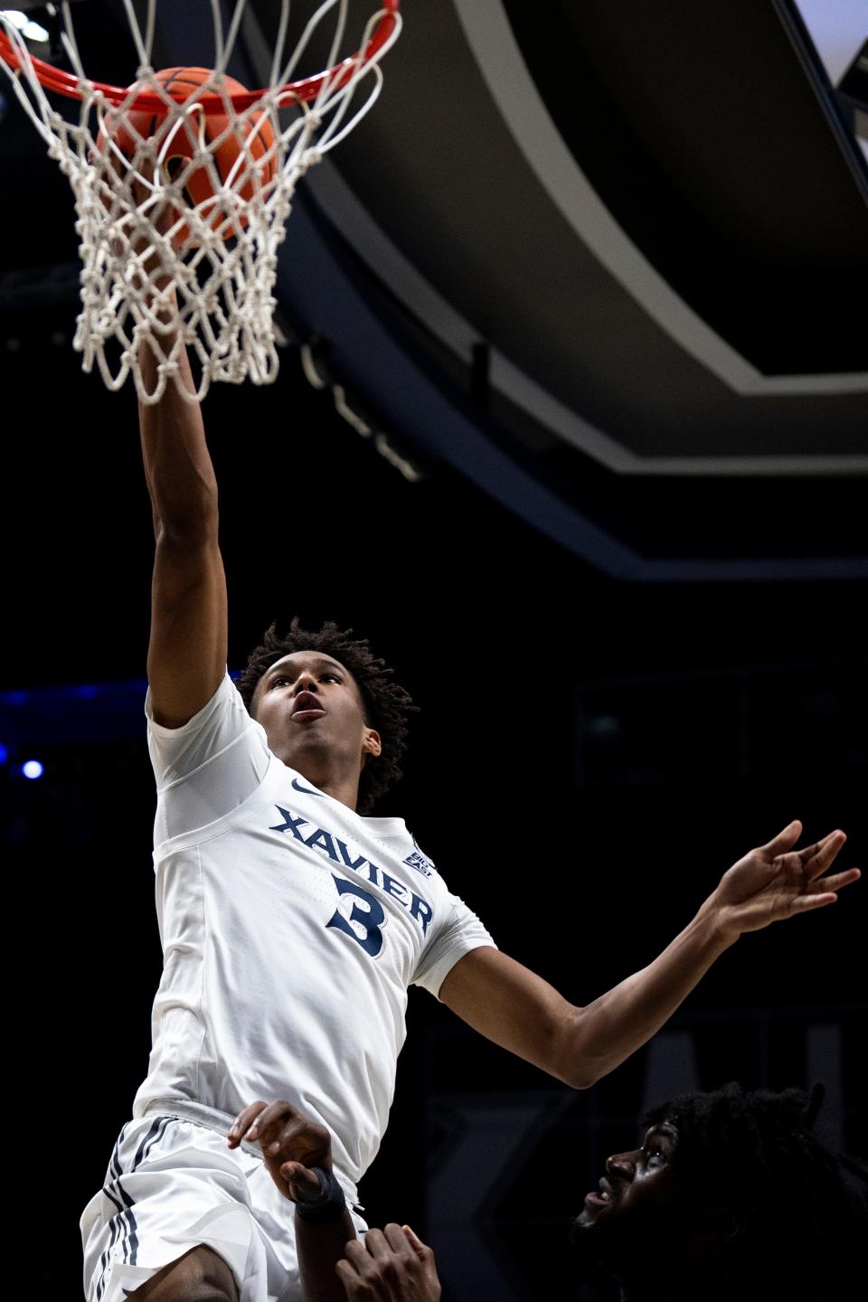 Xavier Musketeers guard-forward Dailyn Swain (3) hits a layup over Seton Hall Pirates center Jaden Bediako (15) in the second half of the basketball game between Xavier Musketeers and Seton Hall Pirates at the Cintas Center in Cincinnati on Saturday, Dec. 23, 2023.