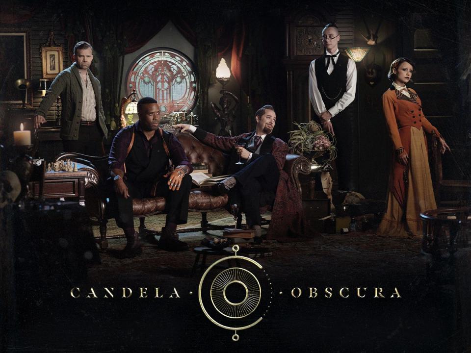 An on-set photo of the cast of the latest installment of Critical Role's Candela Obscura — Liam O'Brien, Imari Williams, Taliesin Jaffe, Alexander Ward, and Aimee Carrero.