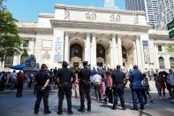 Supporters of author Salman Rushdie attend a reading and rally to show solidarity for free expression at the New York Public Library in New York