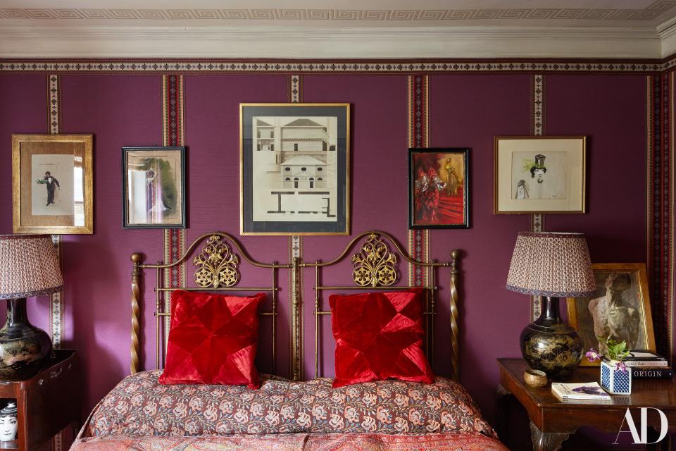 The bedroom’s custom wall covering is an homage to Madeleine Castaing. The bed has a late 19th–century brass headboard and antique Tuscan and Indian linens.