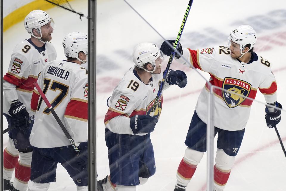 Florida Panthers' Matthew Tkachuk (19) celebrates his goal with teammates Sam Bennett (9), Niko Mikkola (77) and Brandon Montour (62) during the first period of an NHL hockey game against the Boston Bruins, Saturday, April 6, 2024, in Boston. (AP Photo/Michael Dwyer)