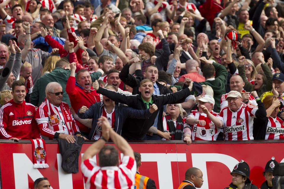 Jubilant Sunderland supporters celebrate a goal by Sebastian Larsson during their English Premier League soccer match against Manchester United at Old Trafford Stadium, Manchester, England, Saturday May 3, 2014. (AP Photo/Jon Super)