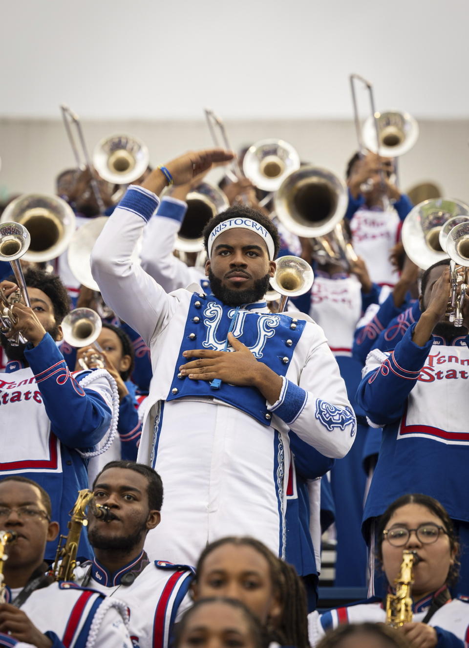 Curtis Olawumi, standing center, appears with other members of the Tennessee State University marching band, during the Southern Heritage Classic football game in Memphis, Tenn., on Sept. 10, 2022. TSU is hoping to make history after their marching band was nominated for a Grammy in the roots gospel category. The historically Black university's Aristocrat of Bands teamed up with gospel songwriter and producer Sir the Baptist last year to record “The Urban Hymnal.” (Garrett E Morris via AP)
