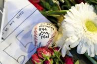 Memorabilia left behind by fans is shown during "A Celebration of Henry Louis Aaron," a memorial service celebrating the life and enduring legacy of the late Hall of Famer and American icon, on Tuesday, Jan. 26, 2021, at Truist Park in Atlanta. (Kevin D. Liles/Atlanta Braves via AP, Pool)