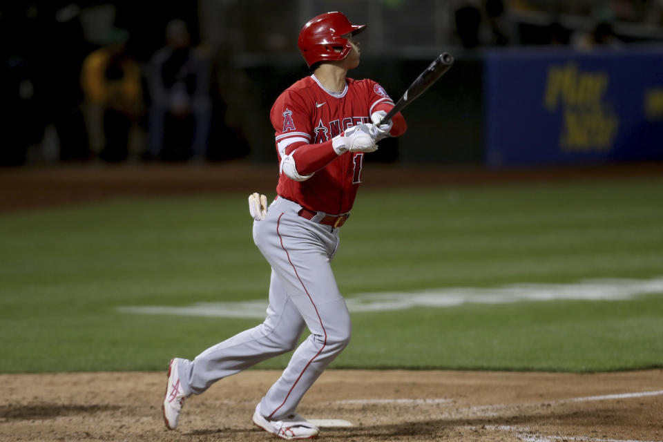 Los Angeles Angels' Shohei Ohtani watches his solo home run against the Oakland Athletics during the eighth inning of a baseball game in Oakland, Calif., Tuesday, June 15, 2021. (AP Photo/Jed Jacobsohn)