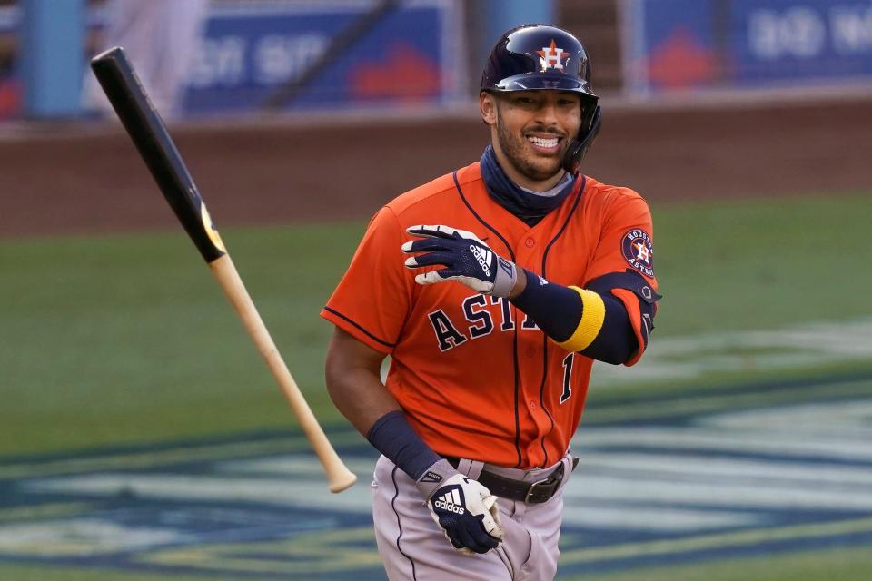 FILE - Houston Astros' Carlos Correa smiles after drawing a walk against the Oakland Athletics during the ninth inning of Game 2 of a baseball American League Division Series in Los Angeles, in this Tuesday, Oct. 6, 2020, file photo. Correa is among roughly 125 players who entered Friday, Jan. 15, 2021, eligible to exchange salary arbitration figures with their teams.(AP Photo/Ashley Landis, File)